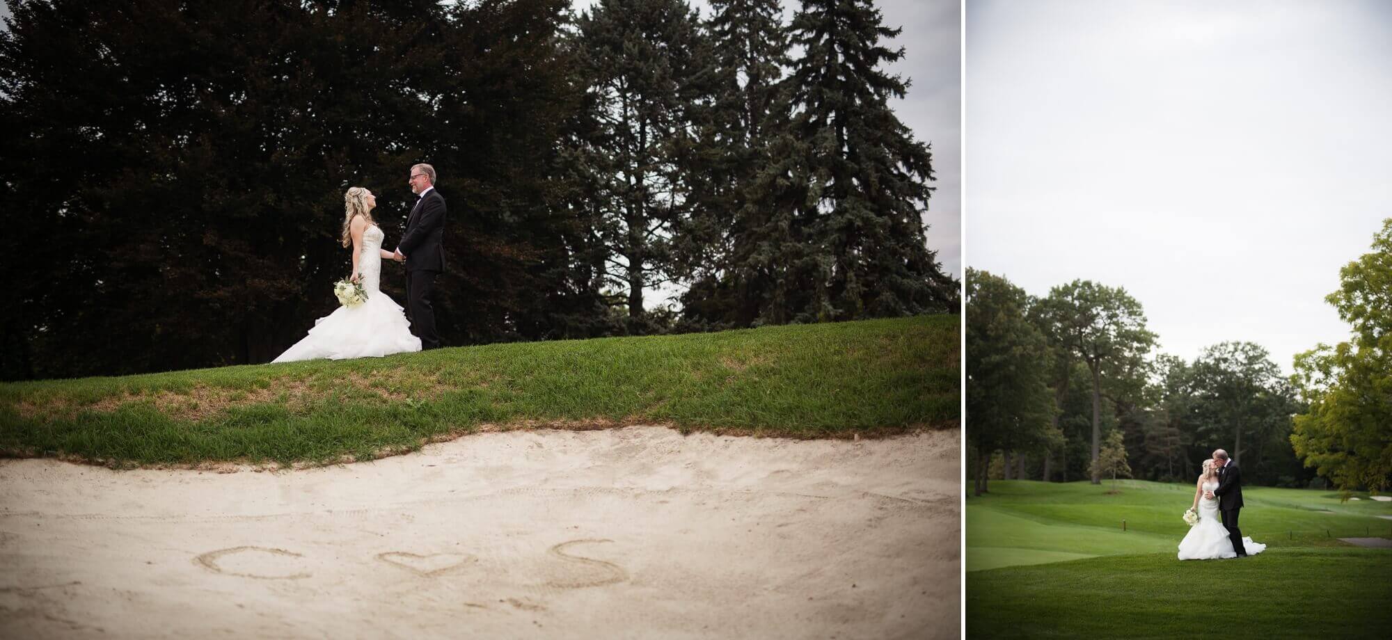 The bride and grooms initials written in the sand at Lambton Golf & Country Club