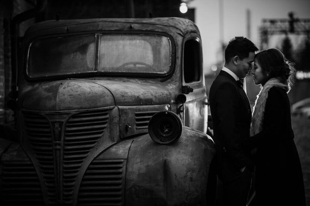 Toronto bride and groom lean against an old truck as they rest heir foreheads together for an intimate wedding shoot.