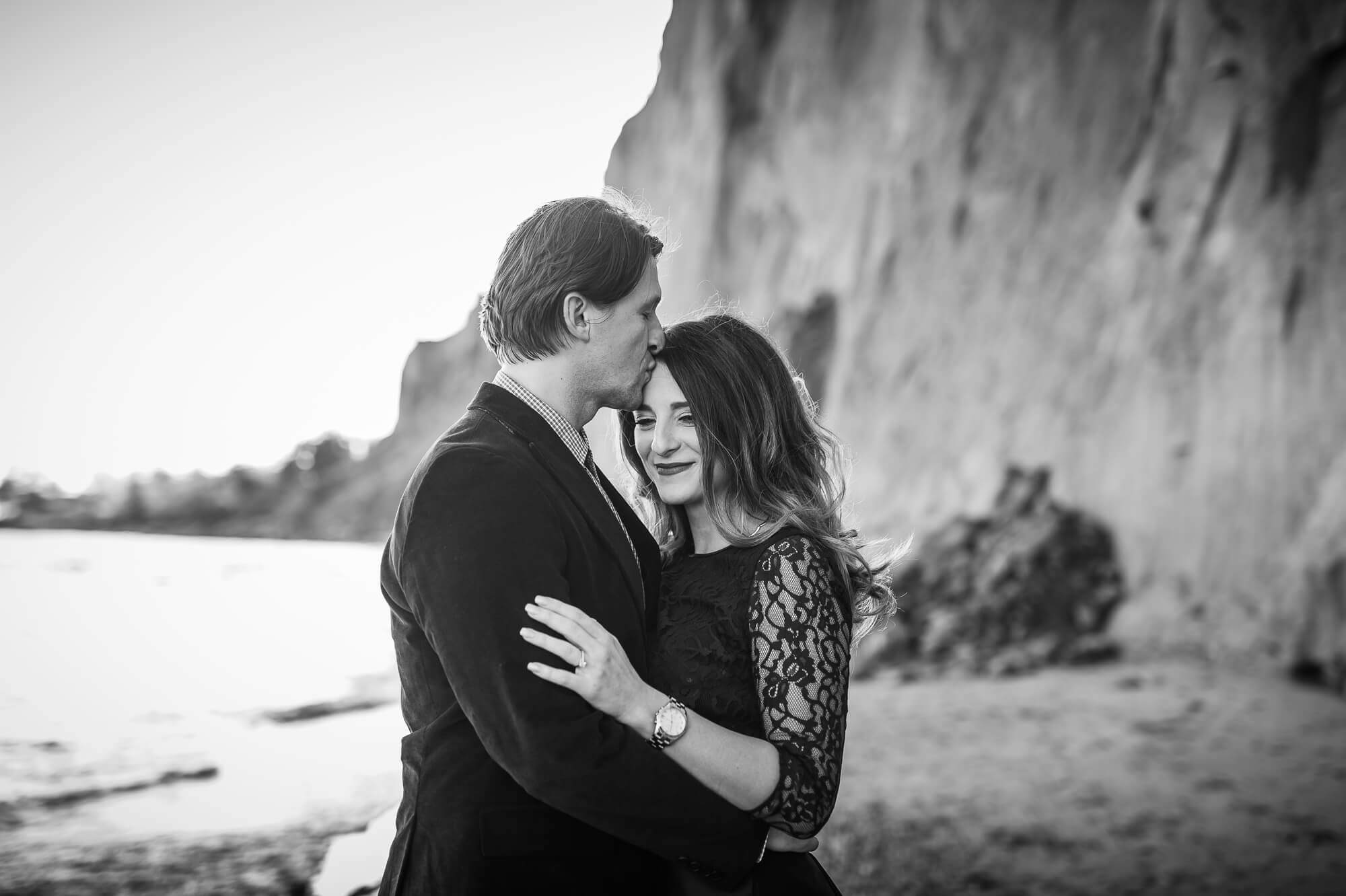 Black and white romantic forehead engagement pose at Scarborough Bluffs in Toronto