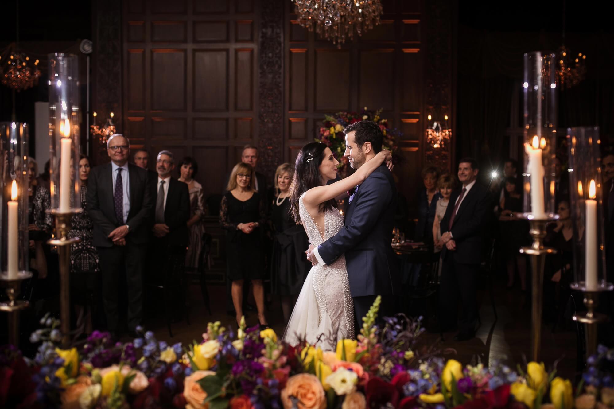 Stunning portrait of the bride and grooms first dance decorated with flowers and candles at Casa Loma in Toronto